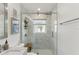 Modern shower with glass door, tile surround, and rainfall showerhead at 3131 W Fielder St, Tampa, FL 33611
