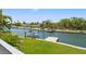 Backyard waterway with a boat lift and lush landscaping at 3901 Pompano Se Dr, St Petersburg, FL 33705
