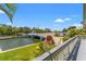 Backyard waterway featuring lush grass, a bridge, and mature trees at 3901 Pompano Se Dr, St Petersburg, FL 33705