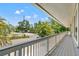 Long, covered balcony with neighborhood views and tropical landscaping at 3901 Pompano Se Dr, St Petersburg, FL 33705