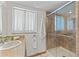 Bathroom highlighting a glass enclosed shower, neutral fixtures, and tiled floors at 3901 Pompano Se Dr, St Petersburg, FL 33705