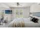 Bedroom features a ceiling fan, french doors leading to the outside, and stylish furnishings at 3901 Pompano Se Dr, St Petersburg, FL 33705
