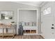 Inviting entryway with a cozy built-in bench, throw pillows and decorative accents with wood laminate flooring at 3901 Pompano Se Dr, St Petersburg, FL 33705