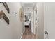 Hallway with decorative mirror leading to bedrooms, with wood laminate flooring at 3901 Pompano Se Dr, St Petersburg, FL 33705