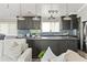 Open kitchen showcasing shaker cabinets, an island with bar seating, and stainless steel appliances at 3901 Pompano Se Dr, St Petersburg, FL 33705
