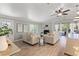 Bright living room featuring a cozy fireplace, neutral decor, and access to an outdoor patio at 3901 Pompano Se Dr, St Petersburg, FL 33705