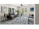 Cozy living room featuring a modern sofa, decorative rug, and natural light at 3901 Pompano Se Dr, St Petersburg, FL 33705