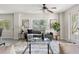 Cozy living room featuring a modern sofa, decorative rug, and natural light at 3901 Pompano Se Dr, St Petersburg, FL 33705