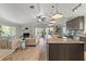 Open-concept living room and kitchen with modern finishes and lots of natural light and a fireplace at 3901 Pompano Se Dr, St Petersburg, FL 33705