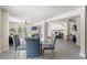 Open-concept living space featuring a dining area, cozy sitting area, and bedroom with gray walls and polished concrete floors at 3901 Pompano Se Dr, St Petersburg, FL 33705