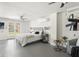 Bright main bedroom with ceiling fans, a bed with side tables, and a walkout to the yard at 3901 Pompano Se Dr, St Petersburg, FL 33705