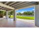 Covered patio with tile flooring and a view of the grassy lawn and waterway at 3901 Pompano Se Dr, St Petersburg, FL 33705