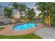 Sparkling pool surrounded by lush tropical landscaping and outdoor seating at dusk at 3901 Pompano Se Dr, St Petersburg, FL 33705