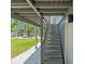 Outdoor staircase leading to the home's entrance, with views of the pool and backyard at 3901 Pompano Se Dr, St Petersburg, FL 33705