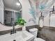 Stylish bathroom featuring modern fixtures, decorative plants, and attractive floral-themed accent wall at 400 38Th Ne Ave, St Petersburg, FL 33703