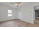 A clean, bright room boasts wood floors, a ceiling fan, closet and access to an ensuite bathroom at 400 38Th Ne Ave, St Petersburg, FL 33703