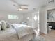 Bright bedroom features a ceiling fan, window, and an ensuite bathroom for a modern feel at 400 38Th Ne Ave, St Petersburg, FL 33703