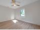 Simple bedroom with hardwood floors, fan and bright window at 400 38Th Ne Ave, St Petersburg, FL 33703