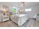 Sun-filled bedroom featuring a ceiling fan, cozy rug, and two windows for natural light at 400 38Th Ne Ave, St Petersburg, FL 33703