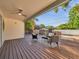 Relaxing covered patio complete with comfortable seating, ceiling fan and a view of the backyard at 400 38Th Ne Ave, St Petersburg, FL 33703