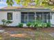 Quaint bungalow with neutral siding, screened porch and lush landscaping at 400 38Th Ne Ave, St Petersburg, FL 33703