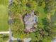 Aerial view of a home with a pool, landscaped grounds, and a brick driveway at 4121 Highland Park Cir, Lutz, FL 33558