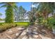 Backyard featuring a stone path leading to a beautiful lake view, surrounded by lush landscaping at 4121 Highland Park Cir, Lutz, FL 33558