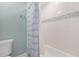 Clean bathroom featuring white subway tile and a bathtub with a shower at 4121 Highland Park Cir, Lutz, FL 33558