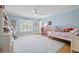 Bright bedroom with a large window, hardwood floors, and plenty of space for play at 4121 Highland Park Cir, Lutz, FL 33558