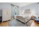 Bedroom features a plush rug, a bed, and matching bedside table, and a window at 4121 Highland Park Cir, Lutz, FL 33558