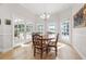Bright dining area featuring a round wooden table and multiple windows overlooking the pool at 4121 Highland Park Cir, Lutz, FL 33558