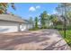 Wide brick driveway leading to a three-car garage and basketball hoop, offering ample parking at 4121 Highland Park Cir, Lutz, FL 33558