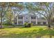 Beautiful two-story home with a symmetrical facade, dark shutters, and a well-manicured front lawn at 4121 Highland Park Cir, Lutz, FL 33558