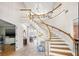 Elegant foyer with a curved staircase, light tile flooring, and soaring ceilings at 4121 Highland Park Cir, Lutz, FL 33558