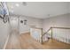 Upstairs hallway with wood floors, curved railing and lots of natural light at 4121 Highland Park Cir, Lutz, FL 33558