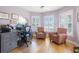 Well-lit home office with hardwood floors, plantation shutters, and a built-in desk at 4121 Highland Park Cir, Lutz, FL 33558