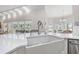 Kitchen area featuring white countertops, stainless faucet and fixtures, and a sink at 4121 Highland Park Cir, Lutz, FL 33558