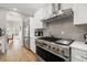 Modern kitchen features stainless steel appliances, white cabinets, and hardwood floors at 4121 Highland Park Cir, Lutz, FL 33558