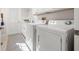 Bright laundry room with washer, dryer, sink, and storage cabinets for convenience at 4121 Highland Park Cir, Lutz, FL 33558
