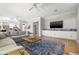 Comfortable living room with a blue rug, built-in cabinets, and a large screen television at 4121 Highland Park Cir, Lutz, FL 33558