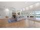 Bright living room with a stone fireplace, French doors to the patio and wood flooring at 4121 Highland Park Cir, Lutz, FL 33558