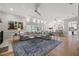 Spacious living room with large windows, hardwood floors, and a comfortable sectional sofa at 4121 Highland Park Cir, Lutz, FL 33558