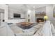 Spacious living room featuring a stone fireplace, TV, built-in cabinets, and wood flooring at 4121 Highland Park Cir, Lutz, FL 33558