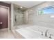 Luxurious main bathroom featuring a jacuzzi tub and a glass-enclosed shower at 4121 Highland Park Cir, Lutz, FL 33558