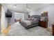 Spacious main bedroom featuring hardwood floors, a ceiling fan, and a comfortable sitting area at 4121 Highland Park Cir, Lutz, FL 33558