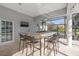 Outdoor bar area with seating and a TV, ideal for enjoying lake views and entertaining guests at 4121 Highland Park Cir, Lutz, FL 33558