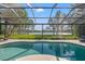 Inviting pool area with a screened enclosure, offering views of the lake and surrounding greenery at 4121 Highland Park Cir, Lutz, FL 33558