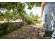Relaxing backyard patio area with a table and chairs, shaded by mature trees at 4610 Courtland St, Tampa, FL 33610