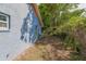 Side yard with a table and chairs. The yard is covered with leaves at 4610 Courtland St, Tampa, FL 33610