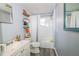 Bright bathroom featuring shelves and a shower/tub combo at 4610 Courtland St, Tampa, FL 33610